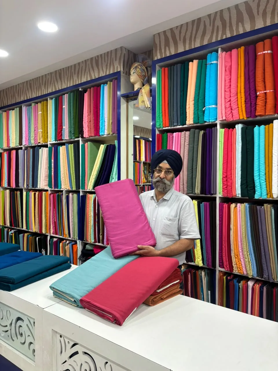 Main shop owner holding fabric inside SAHNEY PAGRI HOUSE